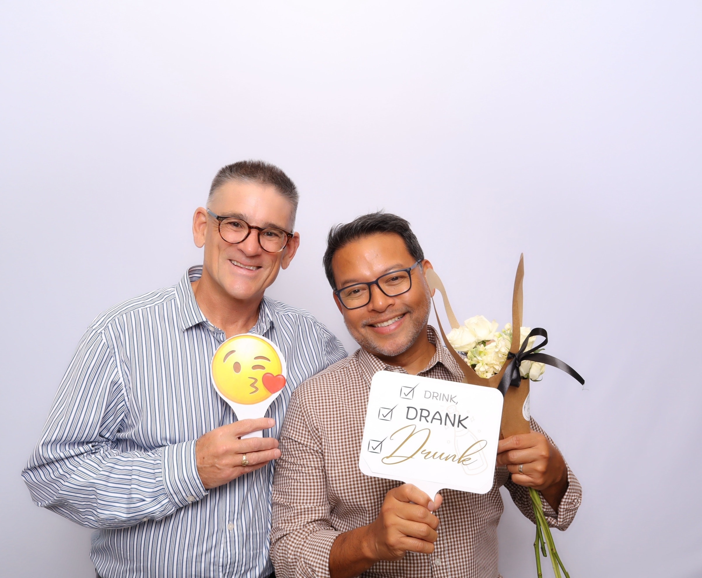 Couple celebrating with photo booth props